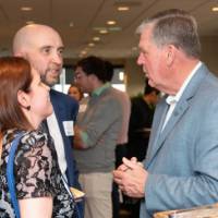 man and woman with talking with tom haas